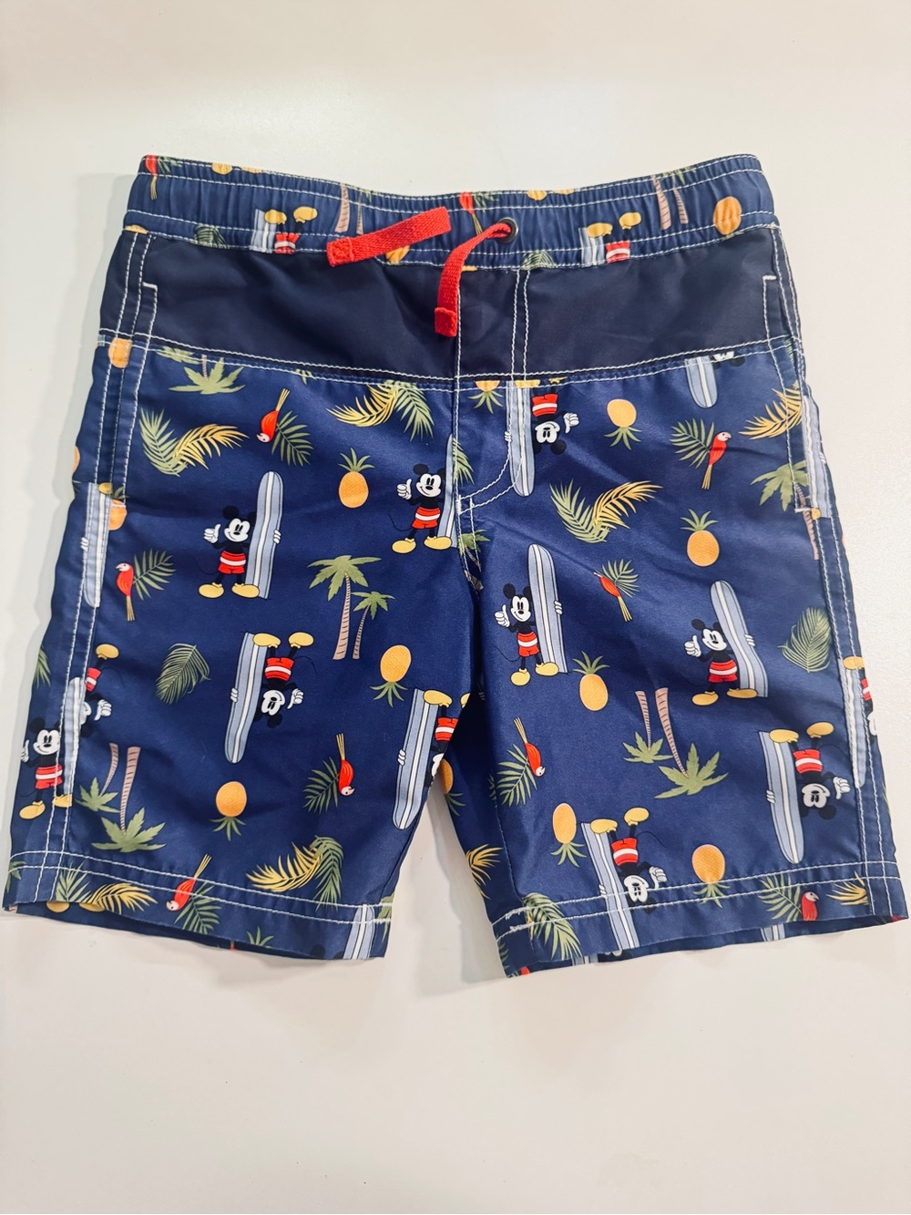 Hanna Andersson Navy Swim Shorts with Red Drawstring and Yellow Pineapple Print